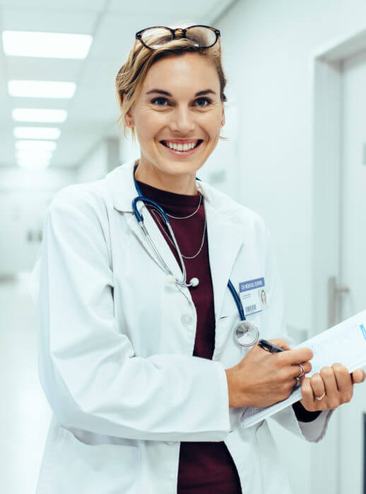 patient-finance-Happy-young-female-doctor-standing-in-hospital corridor