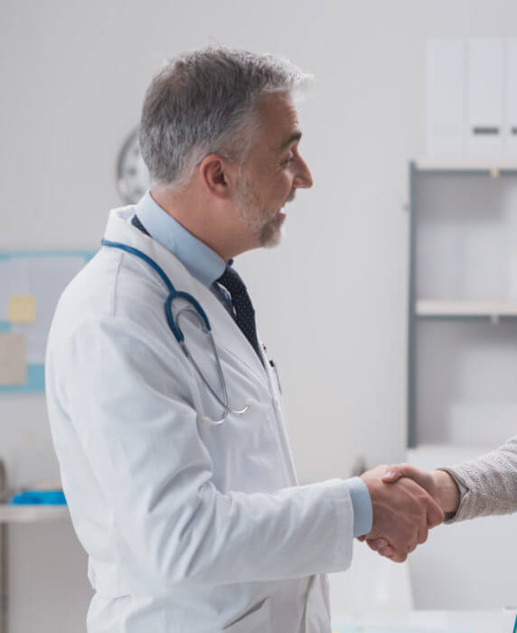 Doctor and patient shaking hands healthcare financing
